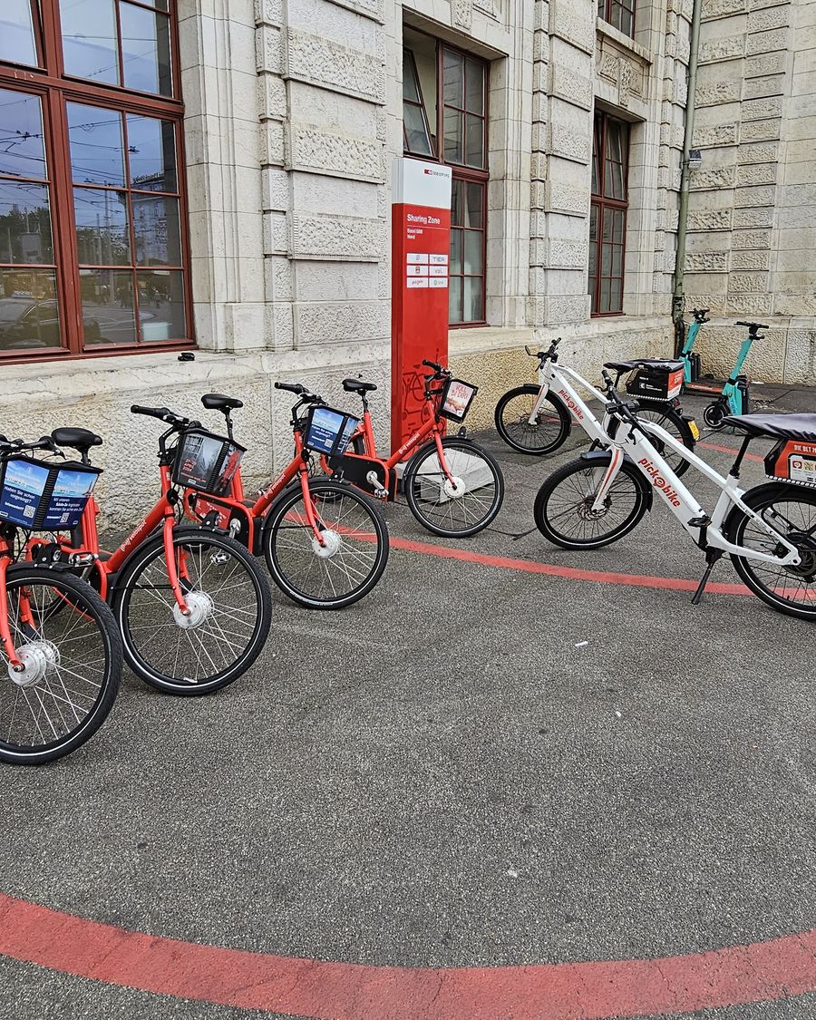 Sharing Zone sign with operator logos at Basel SBB, with Velospot and Pick-e-Bike bikes